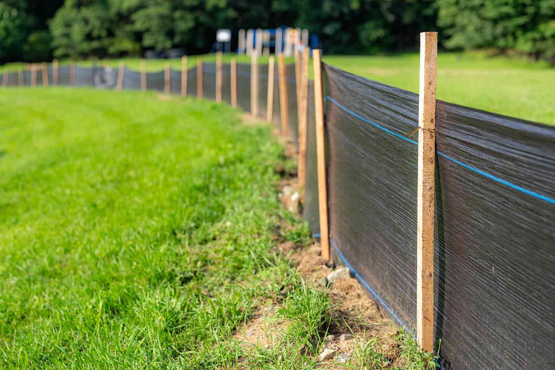 Silt fence installation along a job site perimeter